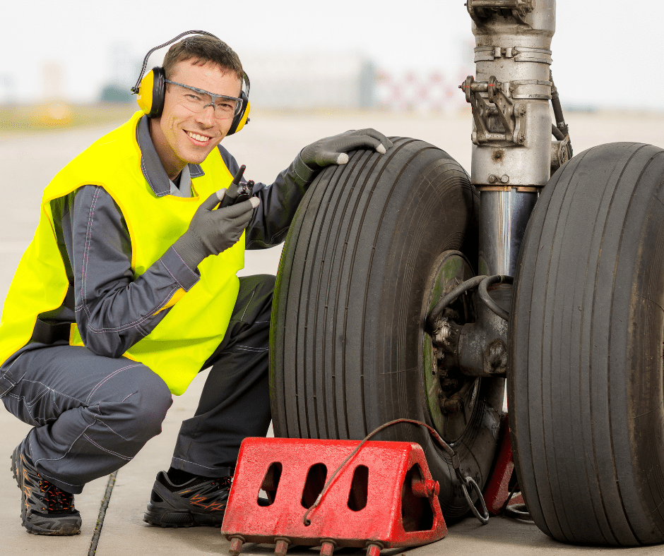 A man in a yellow safety vest stands confidently, emphasizing safety and visibility in his work environment.